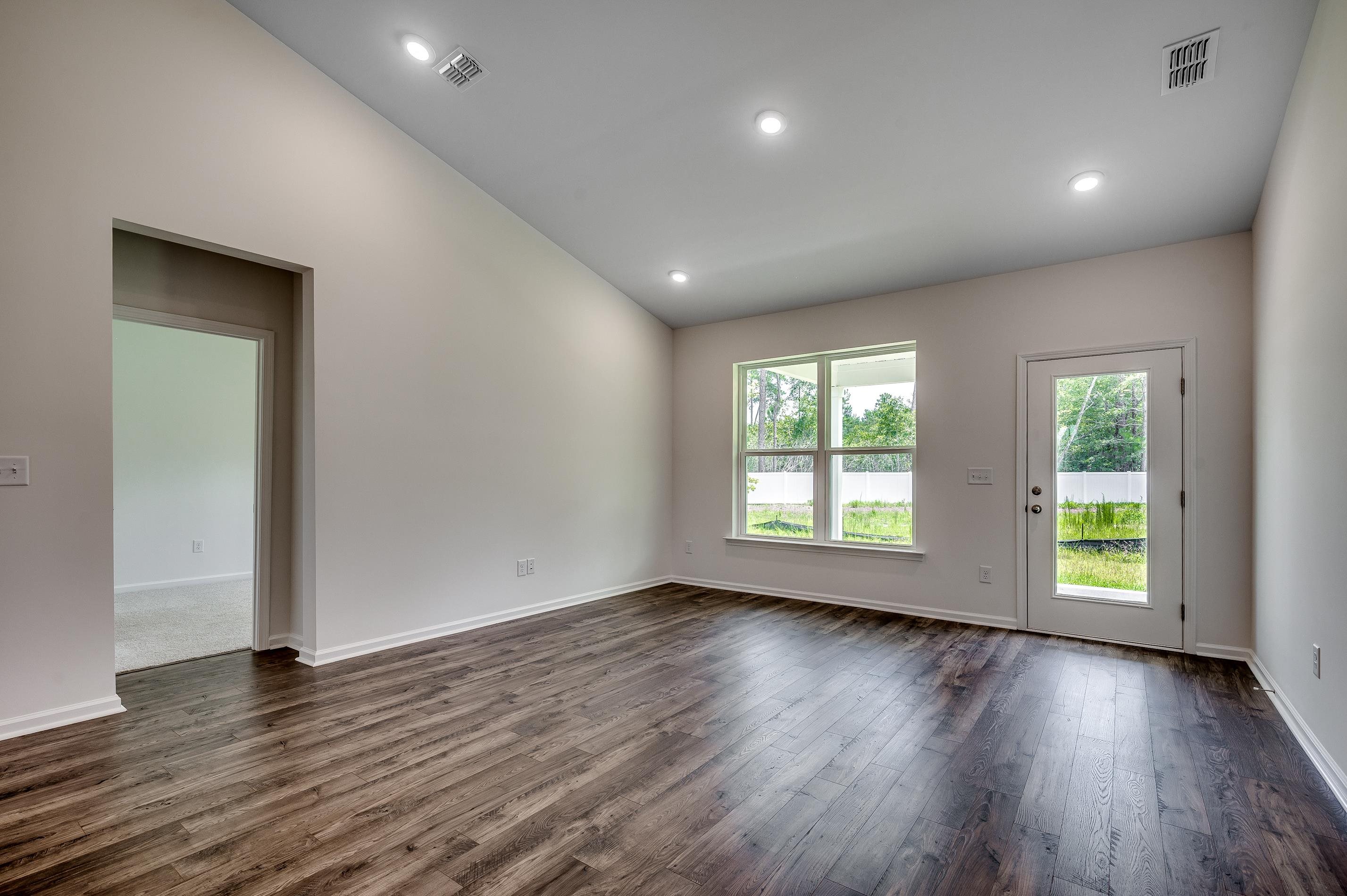 124 Buckingham Drive Loris, SC 29569 - Photo 12 of 17 Unfurnished room with lofted ceiling, dark wood-style flooring, and recessed lighting