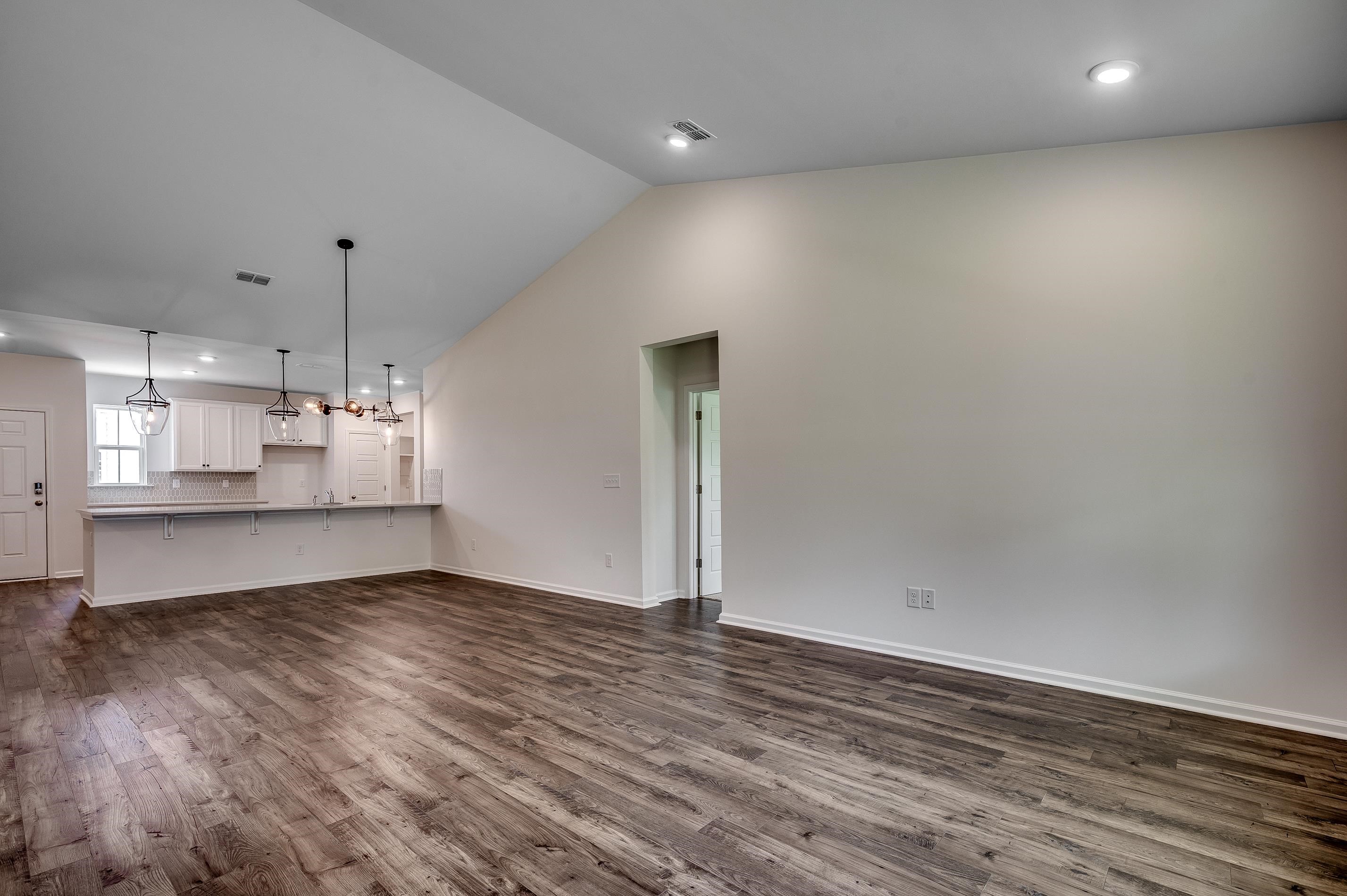 124 Buckingham Drive Loris, SC 29569 - Photo 13 of 17 Unfurnished living room with recessed lighting, dark wood finished floors, and vaulted ceiling