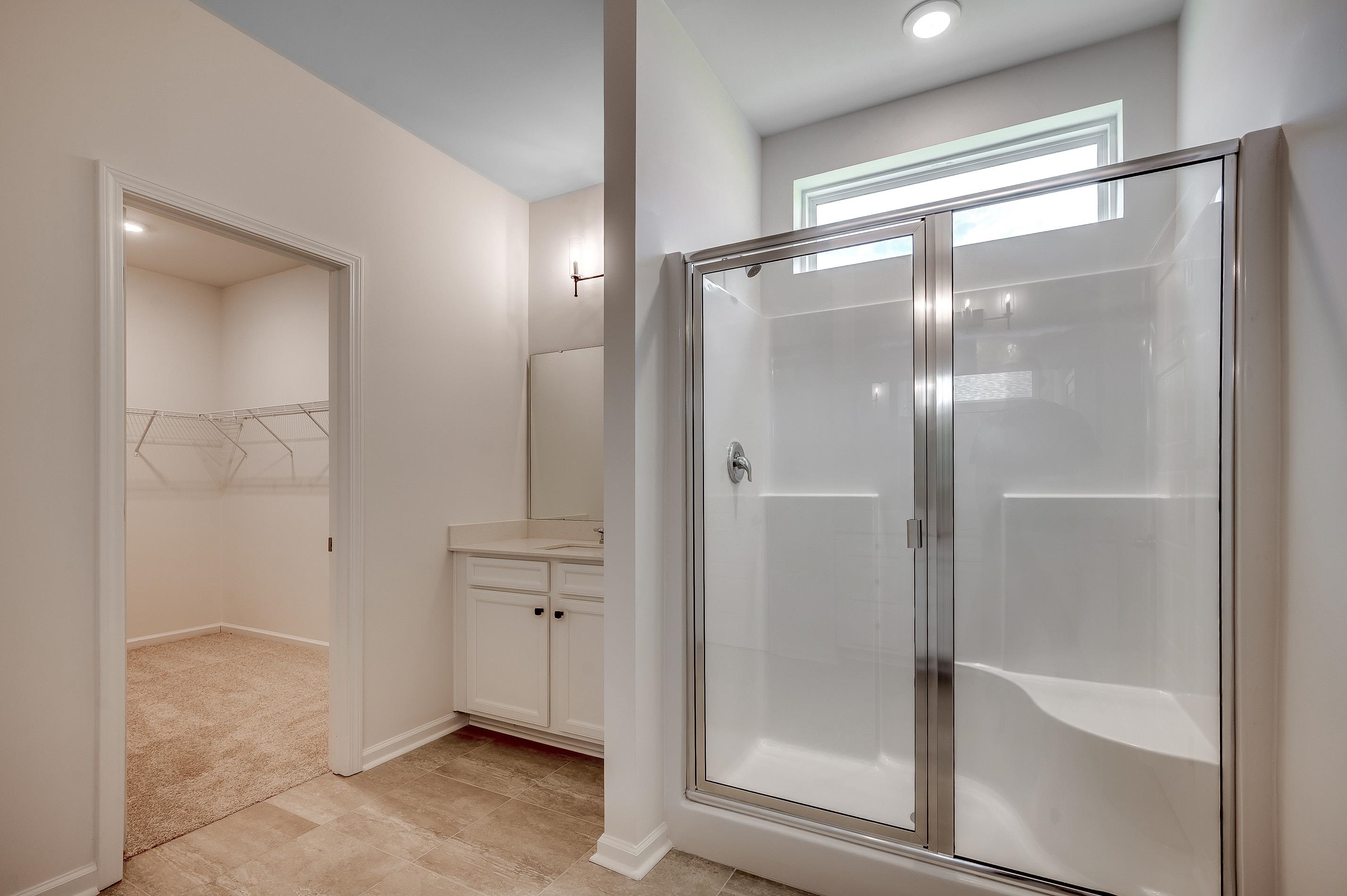 124 Buckingham Drive Loris, SC 29569 - Photo 14 of 17 Bathroom featuring a spacious closet, a shower stall, and vanity
