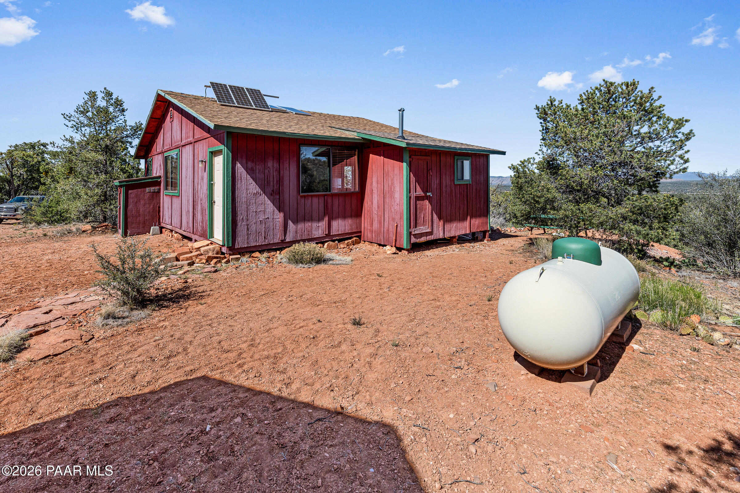 33749 West Whiskey River Road, Unit 21 Seligman, AZ 86337 - Photo 22 of 41 a backyard of a house with table and chairs