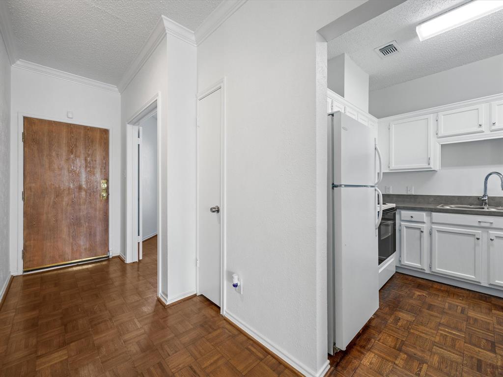 5310 Keller Springs Road, Unit 332 Dallas, TX 75248 - Photo 18 of 38 a kitchen with a refrigerator and a sink