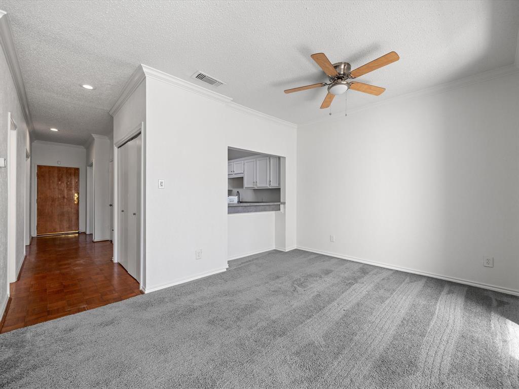 5310 Keller Springs Road, Unit 332 Dallas, TX 75248 - Photo 22 of 38 a view of empty room with wooden floor and ceiling fan