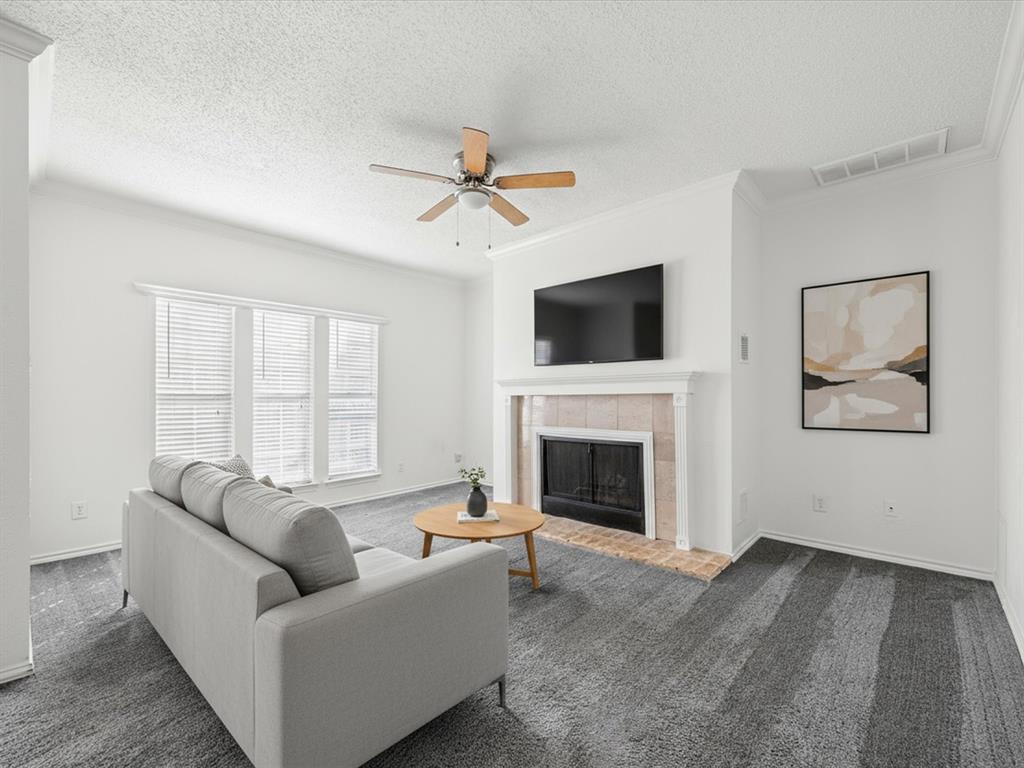 5310 Keller Springs Road, Unit 332 Dallas, TX 75248 - Photo 4 of 38 a living room with furniture a fireplace and a flat screen tv