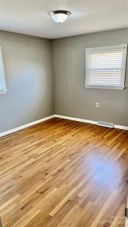 6440 Miller Road Kannapolis, NC 28081 - Photo 10 of 15 an empty room with wooden floor and windows