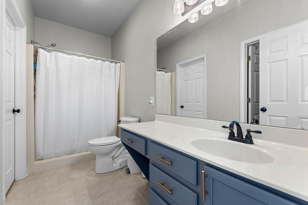 21 B Edinburgh Street Valparaiso, IN 46385 - Photo 11 of 17 a bathroom with a double vanity sink toilet and mirror