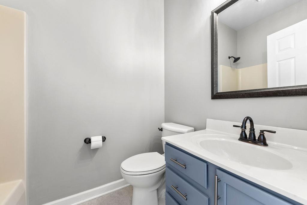 21 B Edinburgh Street Valparaiso, IN 46385 - Photo 15 of 17 a bathroom with a sink a toilet and mirror