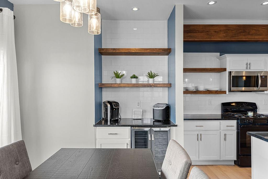 21 B Edinburgh Street Valparaiso, IN 46385 - Photo 6 of 17 a kitchen with stainless steel appliances white cabinets and wooden floor