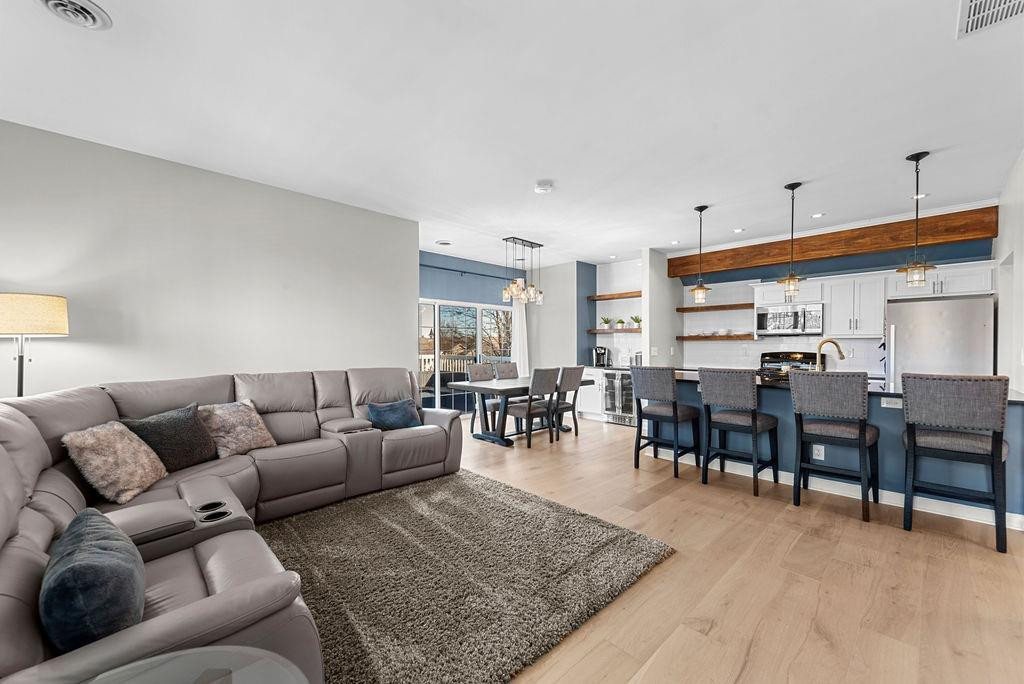 21 B Edinburgh Street Valparaiso, IN 46385 - Photo 8 of 17 a living room with furniture a dining table and kitchen view
