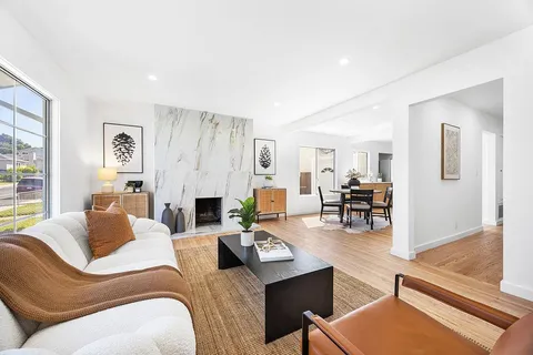 a living room with fireplace furniture and a wooden floor