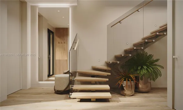 a view of entryway with wooden floor and windows