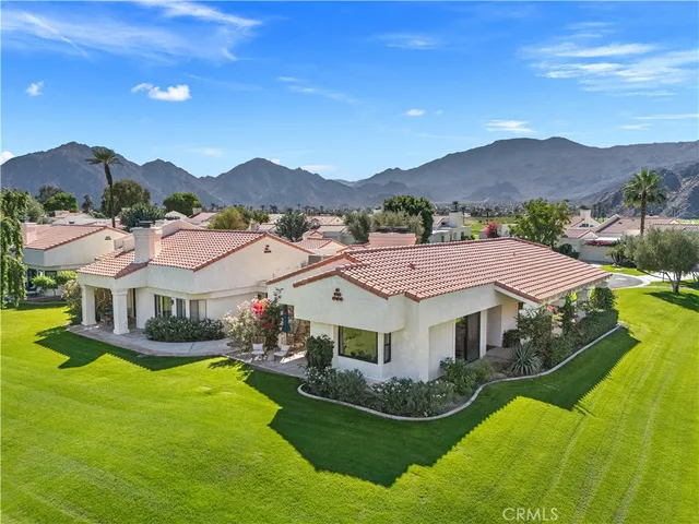 a aerial view of a house with swimming pool and a yard