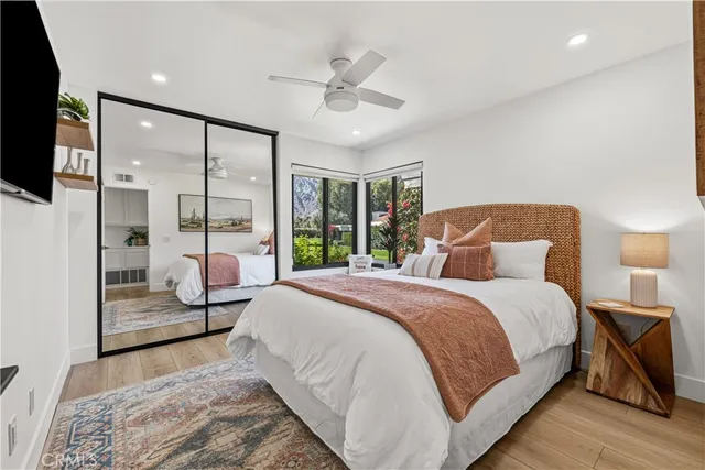 a bedroom with a large bed and a chandelier