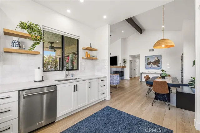 a large kitchen with cabinets and wooden floor