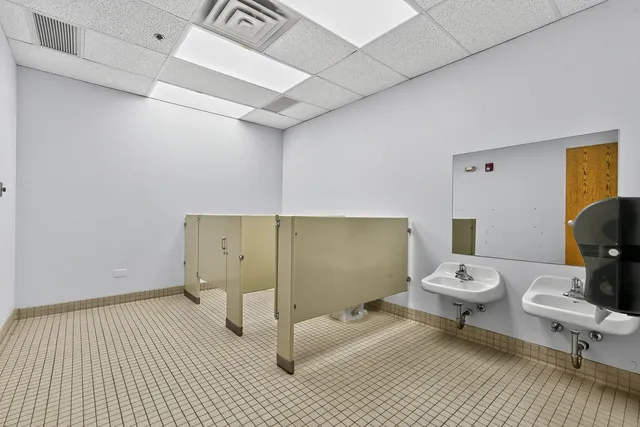 a bedroom with a bed and a mirror