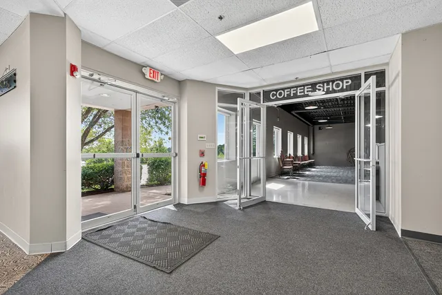 a view of a big room with wooden floor and windows