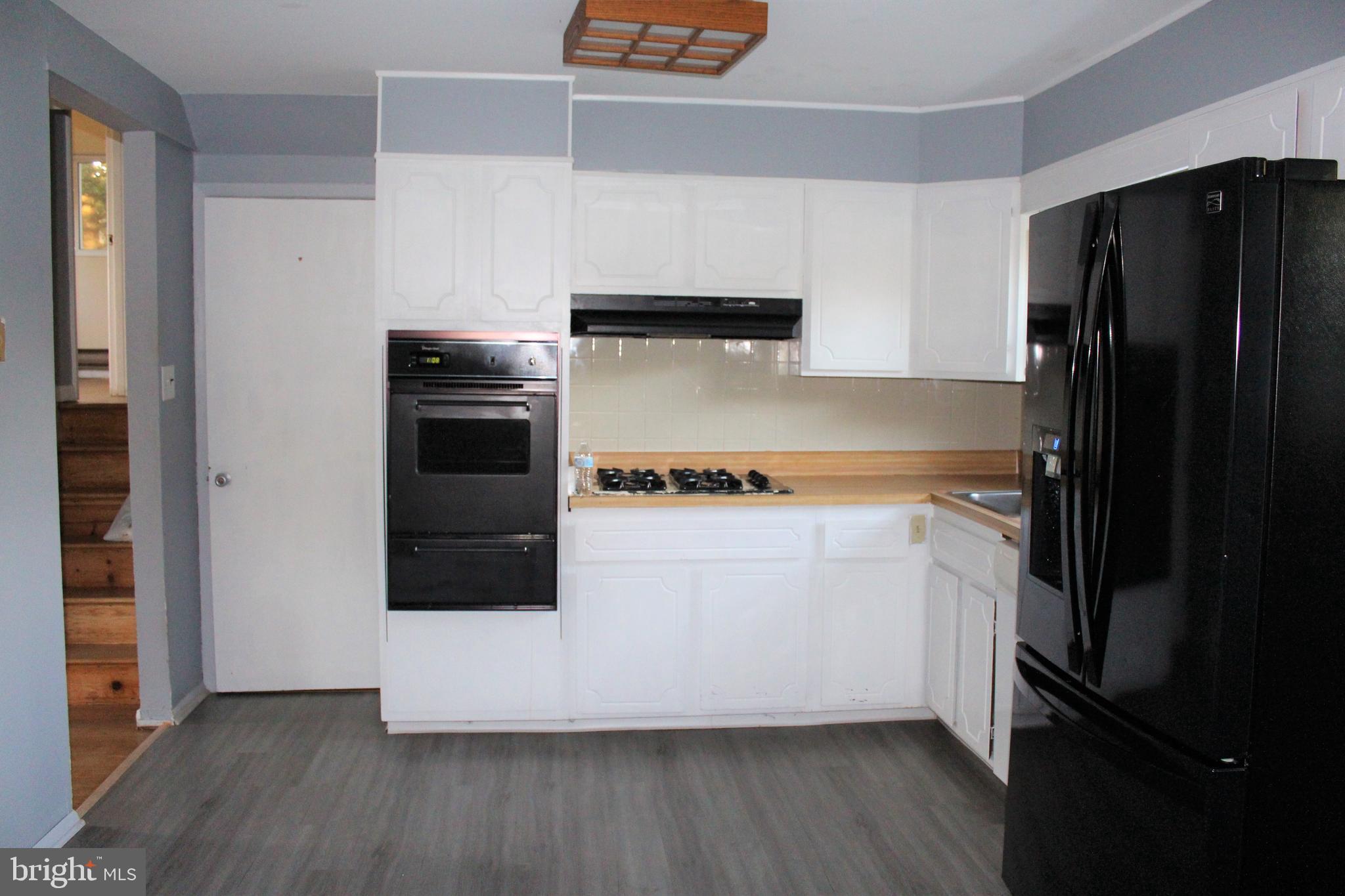 413 Dickinson Road Glassboro, NJ 08028 - Photo 8 of 16 a kitchen with a refrigerator and a stove