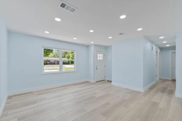 a view of an empty room with a window
