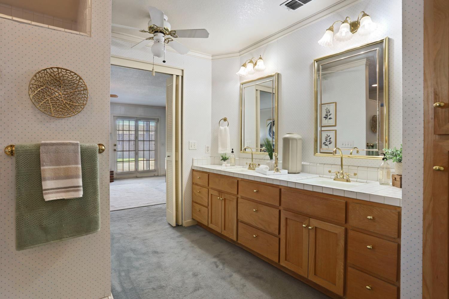 3152 Sea Gull Lane Stockton, CA 95219 - Photo 15 of 67 a spacious bathroom with a double vanity sink and a mirror