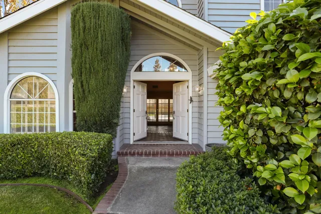 a front view of a house with a garden