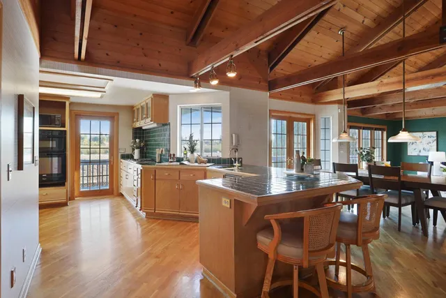 a dining room with furniture window and wooden floor