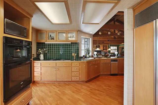 a living room with fireplace furniture and a large window