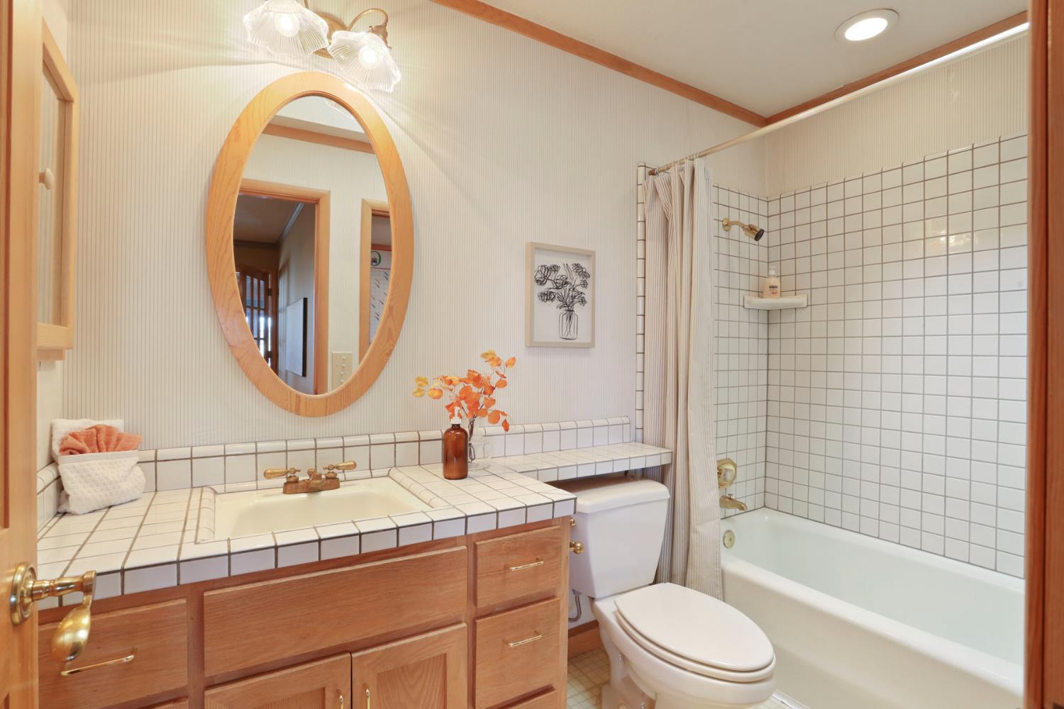 3152 Sea Gull Lane Stockton, CA 95219 - Photo 49 of 67 a bathroom with a bathtub sink mirror vanity and toilet