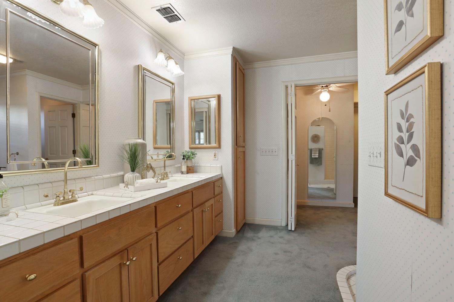 3152 Sea Gull Lane Stockton, CA 95219 - Photo 8 of 67 a spacious bathroom with a double vanity sink a mirror and a shower