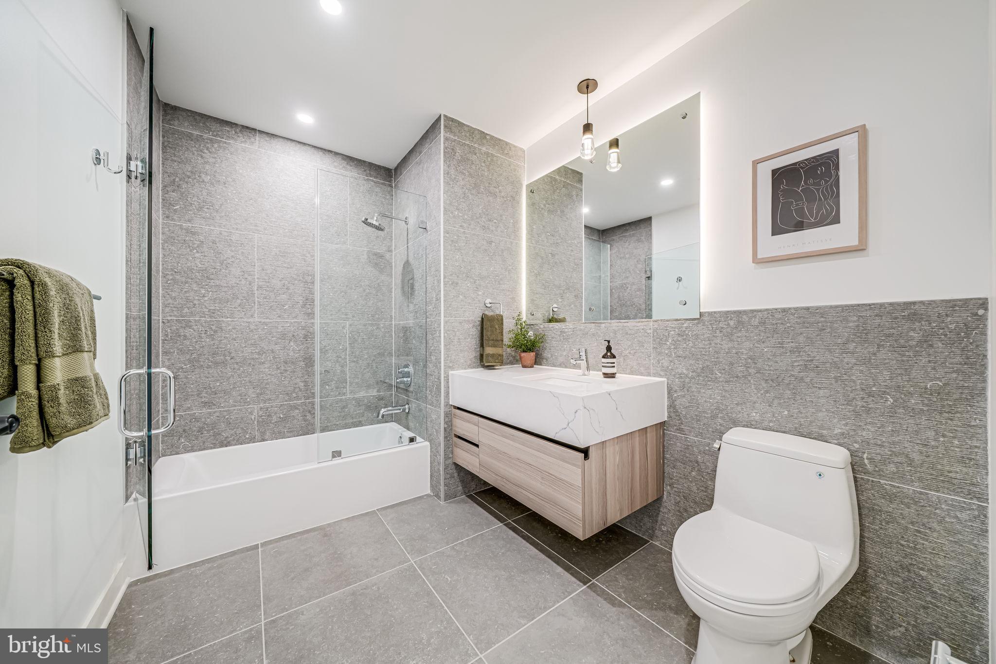 2903 Newark Street Northwest Washington, DC 20008 - Photo 15 of 36 a bathroom with a bathtub sink mirror and toilet
