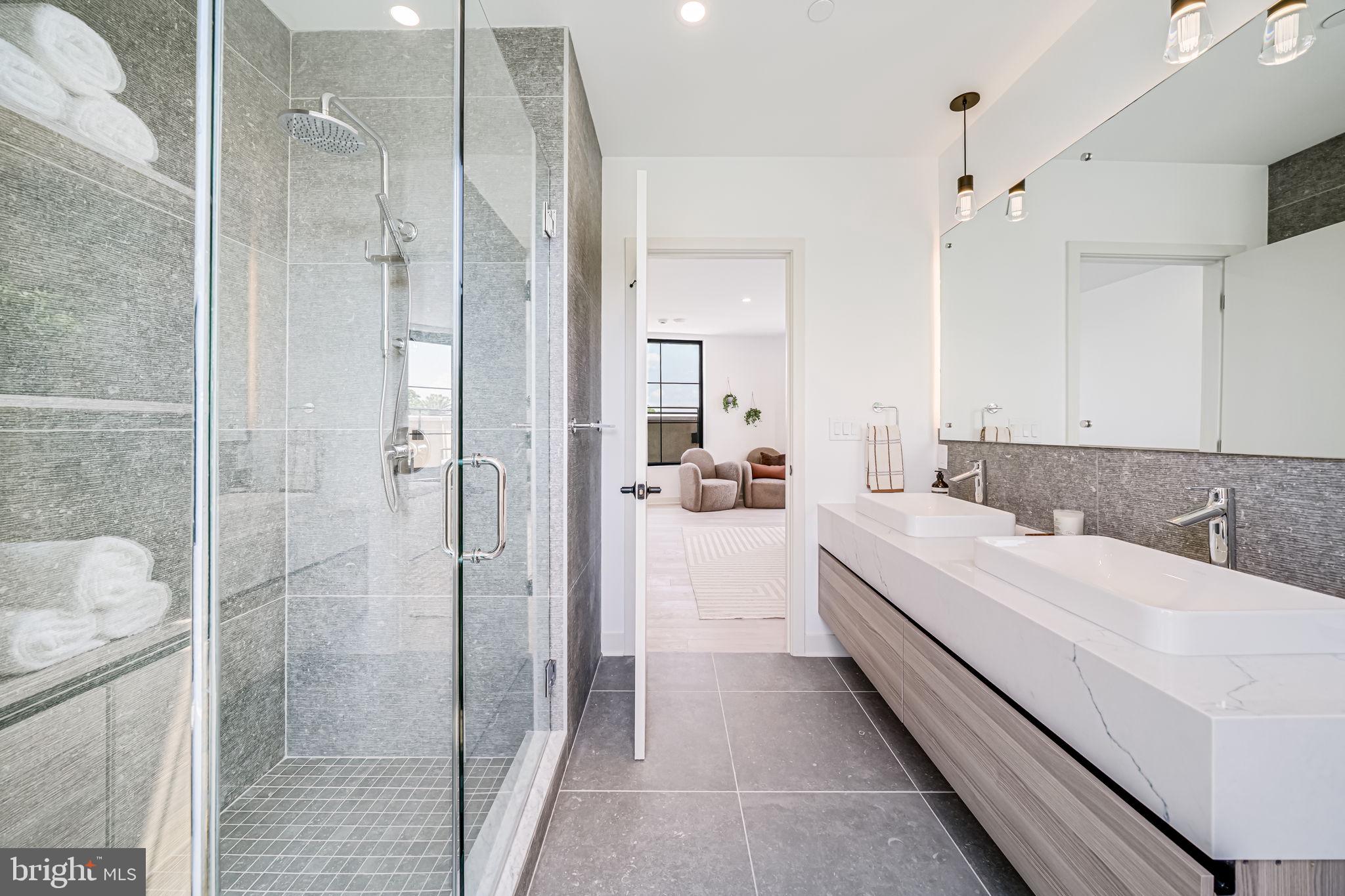 2903 Newark Street Northwest Washington, DC 20008 - Photo 21 of 36 a bathroom with a double vanity sink and mirror