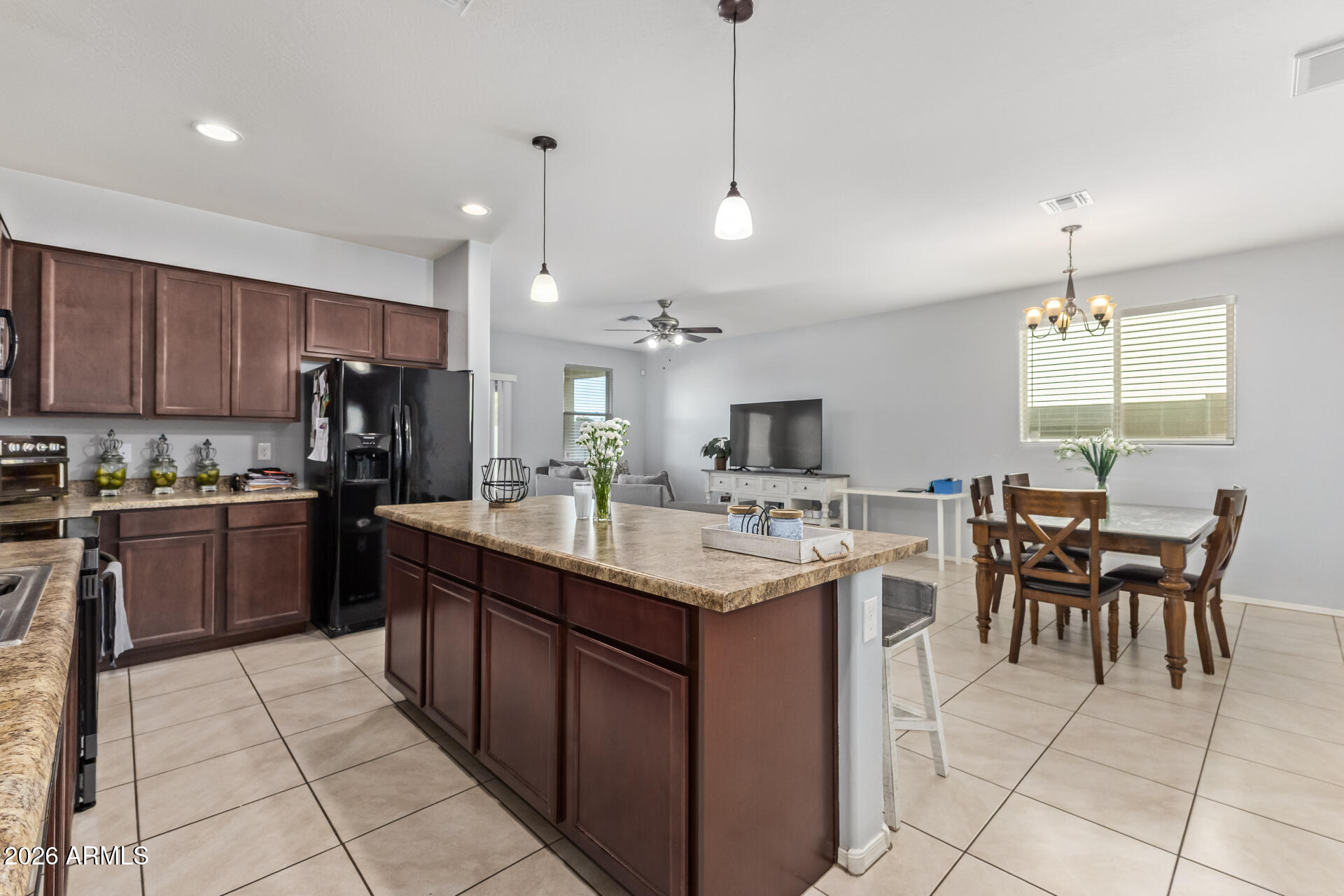 10326 West Payson Road Tolleson, AZ 85353 - Photo 11 of 27 a kitchen with kitchen island granite countertop a sink counter top space appliances and cabinets