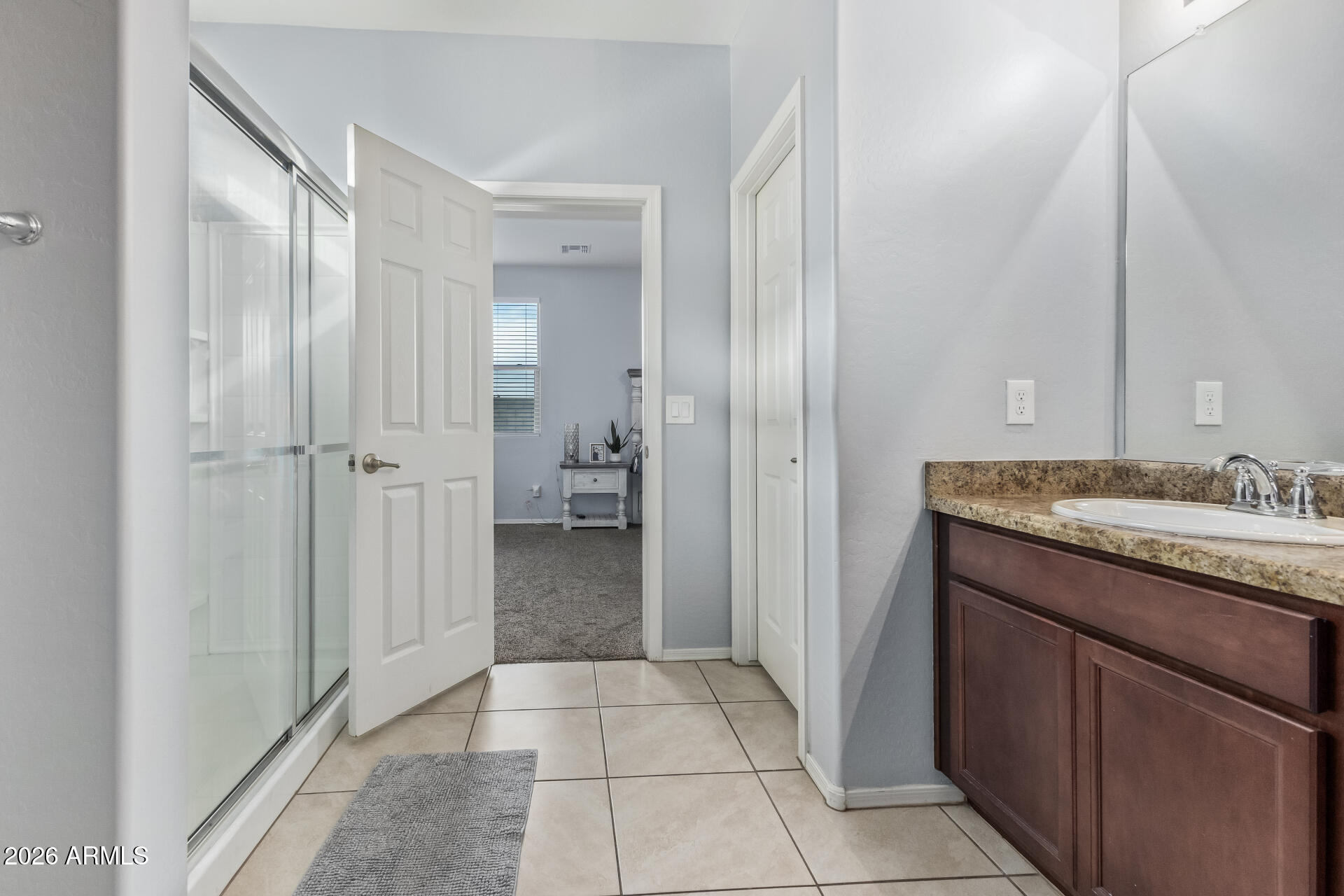 10326 West Payson Road Tolleson, AZ 85353 - Photo 16 of 27 a bathroom with a granite countertop sink and a mirror