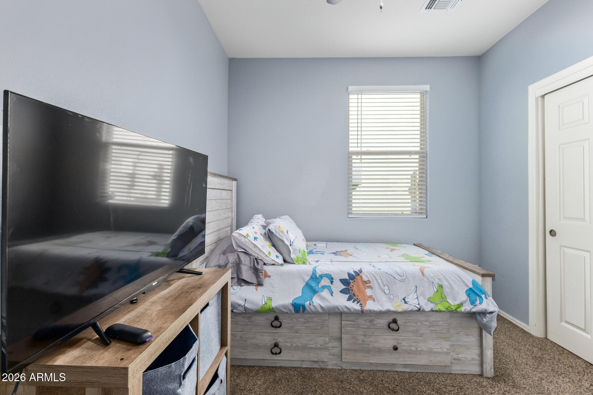 10326 West Payson Road Tolleson, AZ 85353 - Photo 17 of 27 a bedroom with a bed and window
