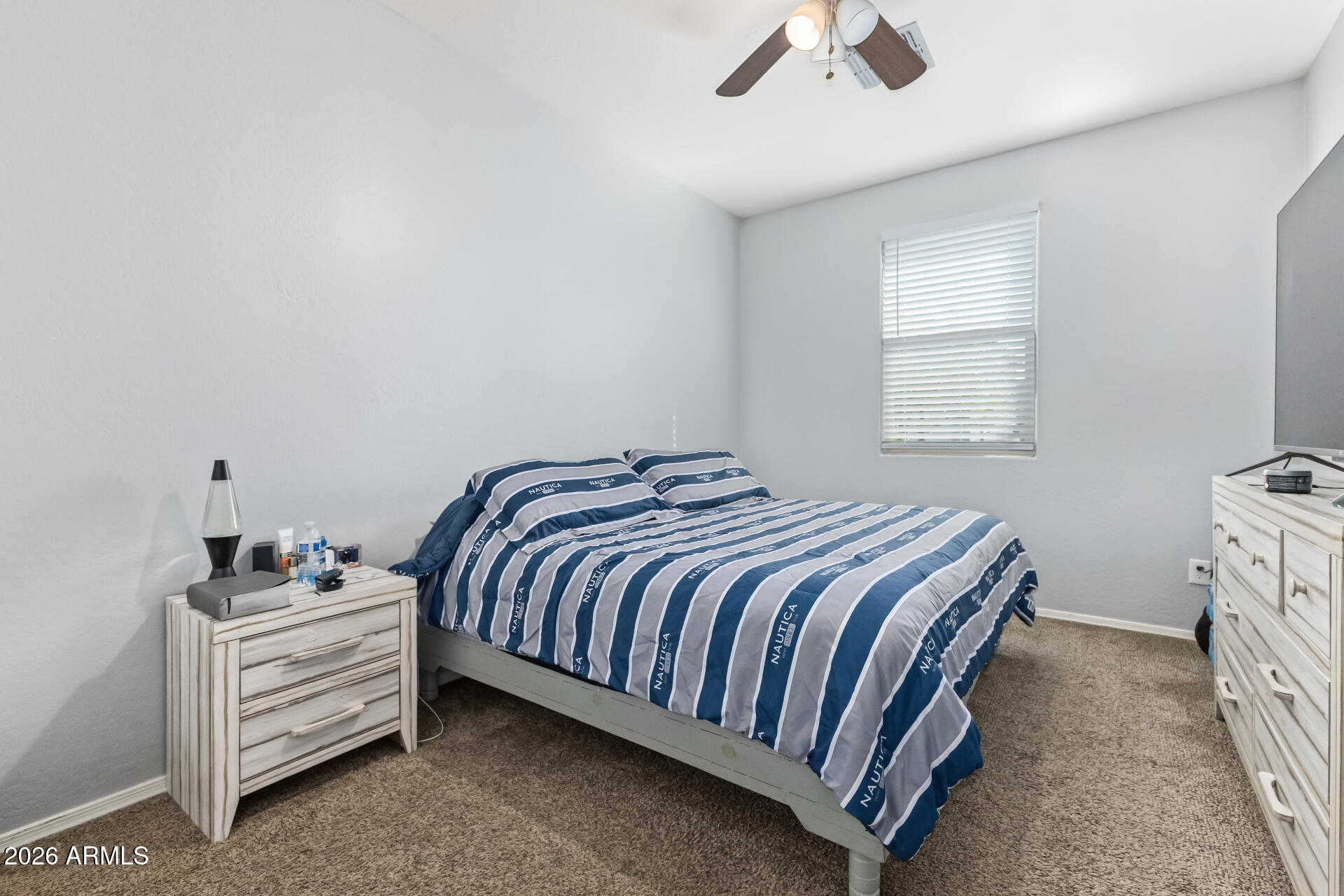 10326 West Payson Road Tolleson, AZ 85353 - Photo 22 of 27 a bedroom with a bed and a window