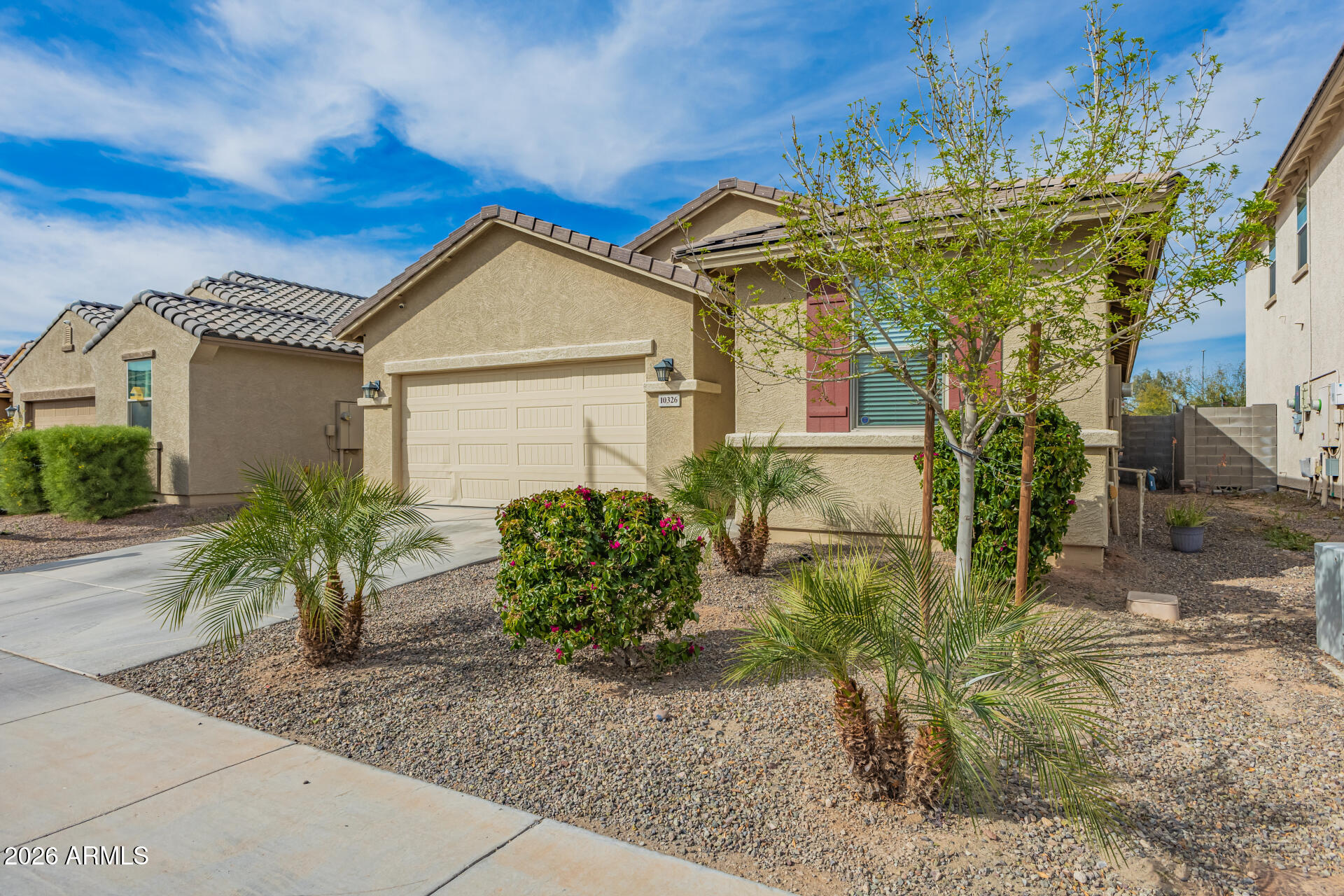 10326 West Payson Road Tolleson, AZ 85353 - Photo 5 of 27 a view of a house with fountain and plants