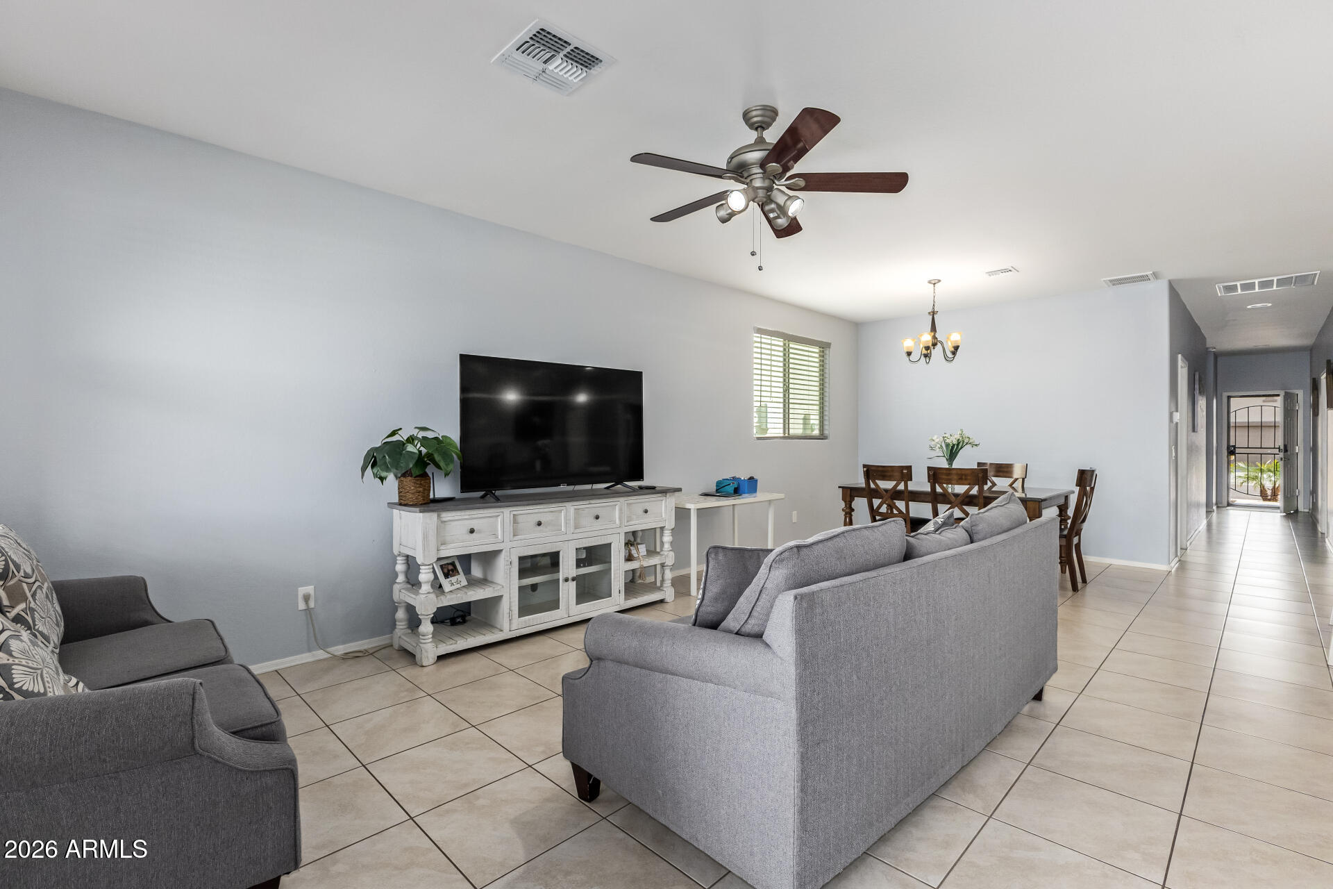 10326 West Payson Road Tolleson, AZ 85353 - Photo 8 of 27 a living room with furniture and a flat screen tv