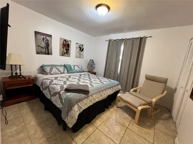 a bedroom with a bed and a chair