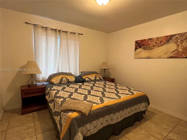 a bedroom with a bed and a chair