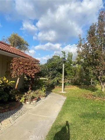 a view of a pathway with a wrought fence