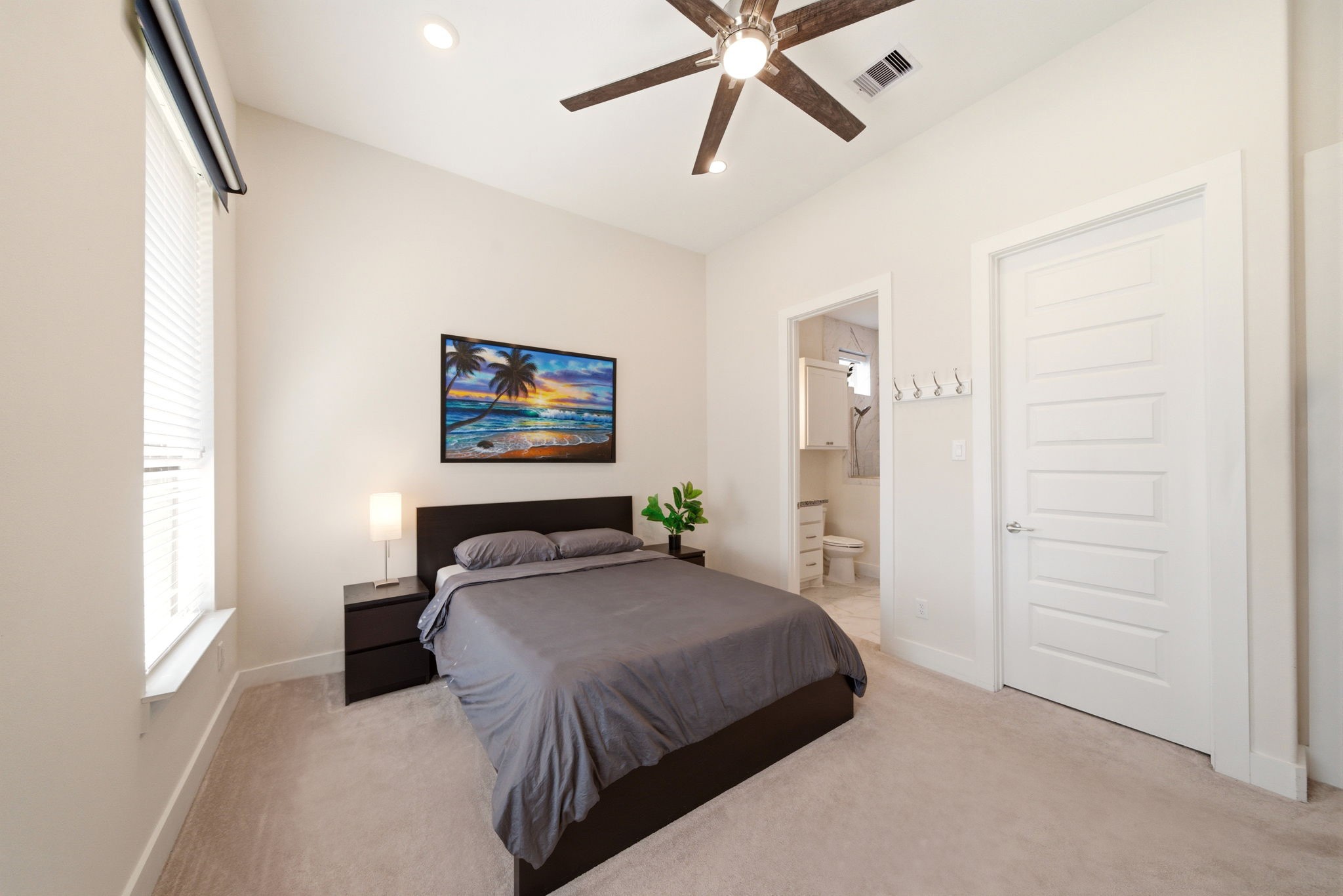 28811 Ember Crest Lane Fulshear, TX 77441 - Photo 11 of 47 a bedroom with a bed and a chandelier