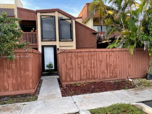 a view of a house with wooden fence