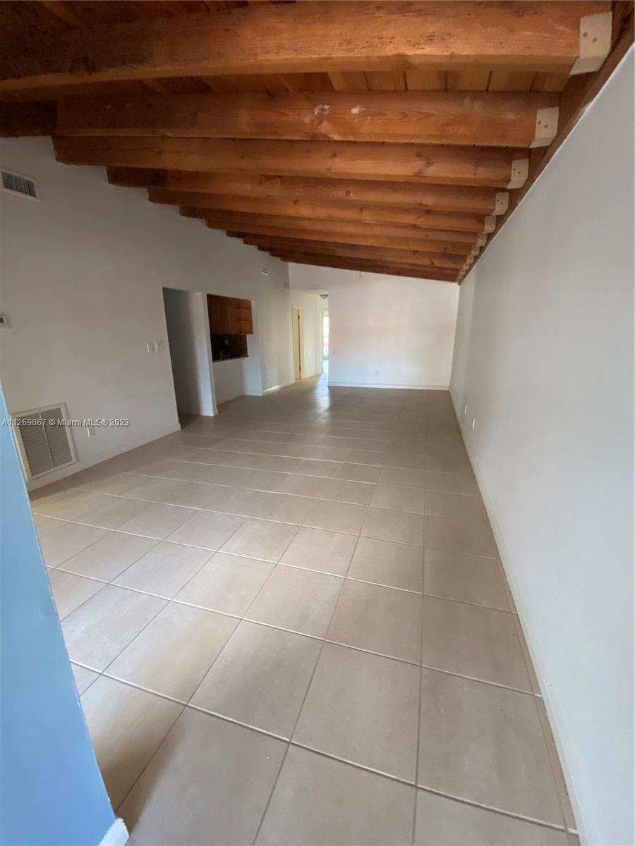 6934 Southwest 114th Place, Unit F55 Miami, FL 33173 - Photo 3 of 10 a view of an empty room with a window