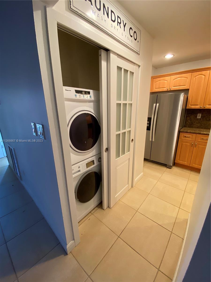 6934 Southwest 114th Place, Unit F55 Miami, FL 33173 - Photo 4 of 10 a utility room with dryer and washer