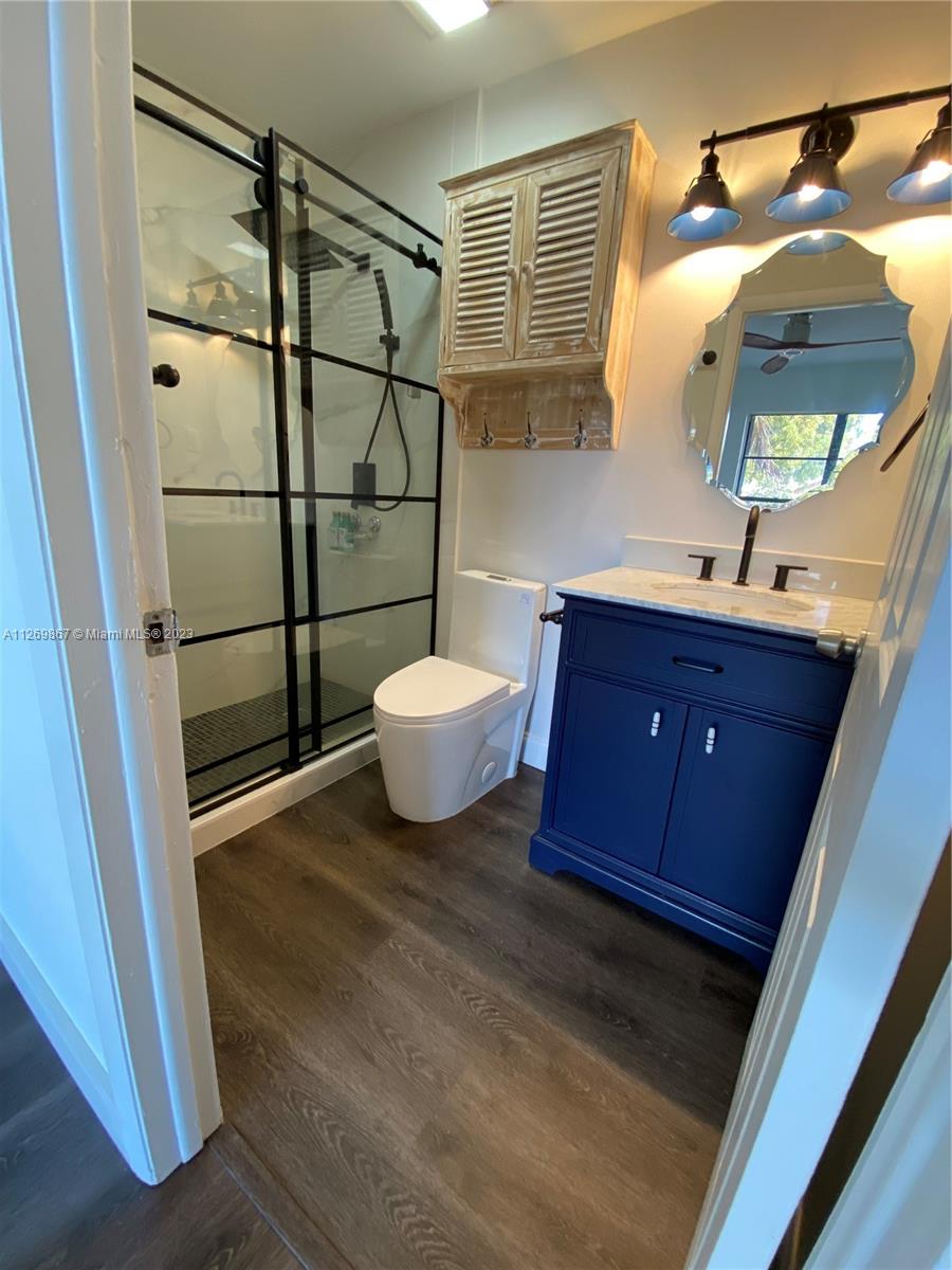 6934 Southwest 114th Place, Unit F55 Miami, FL 33173 - Photo 5 of 10 a bathroom with a sink and a mirror