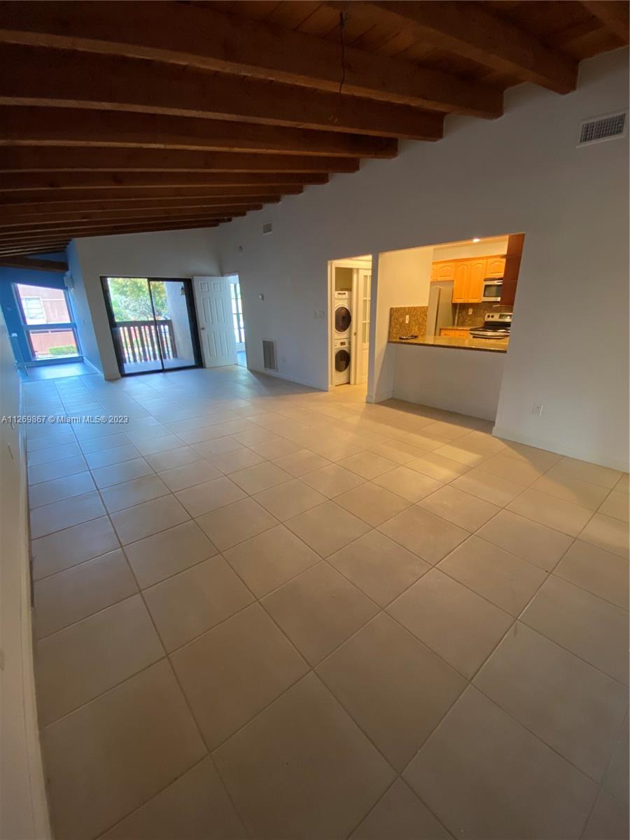 6934 Southwest 114th Place, Unit F55 Miami, FL 33173 - Photo 9 of 10 a view of an empty room and window