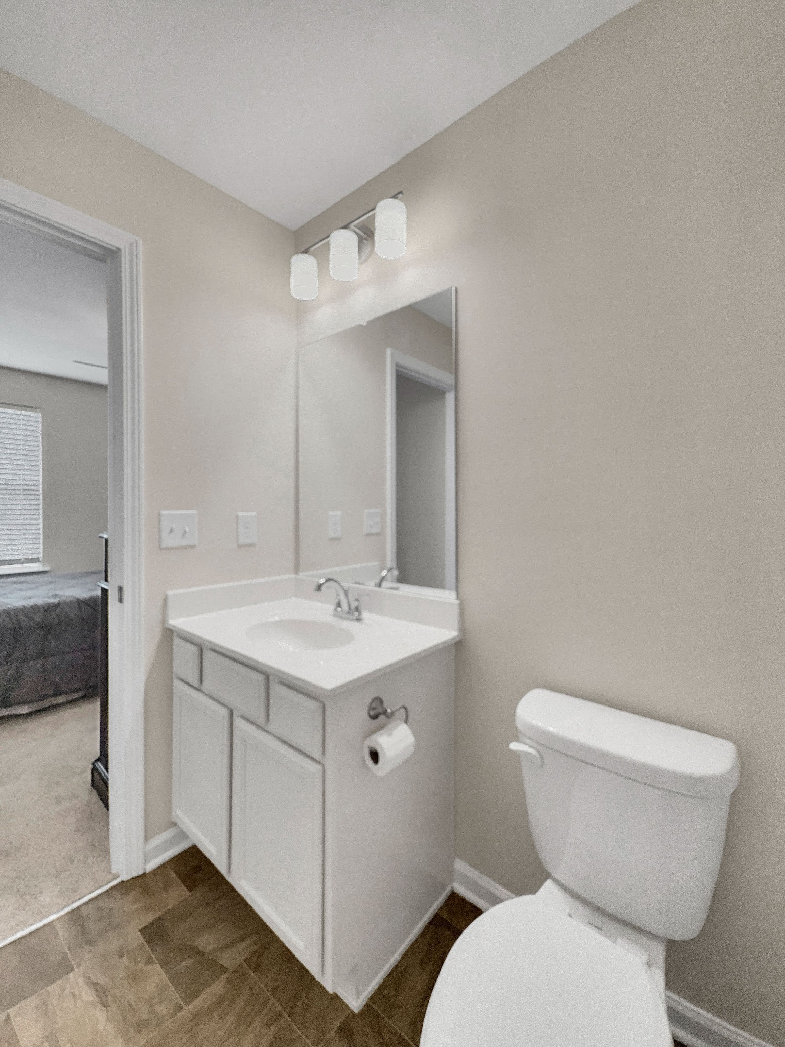 147 Addi Street Pleasant View, TN 37146 - Photo 22 of 27 a bathroom with a toilet sink and mirror