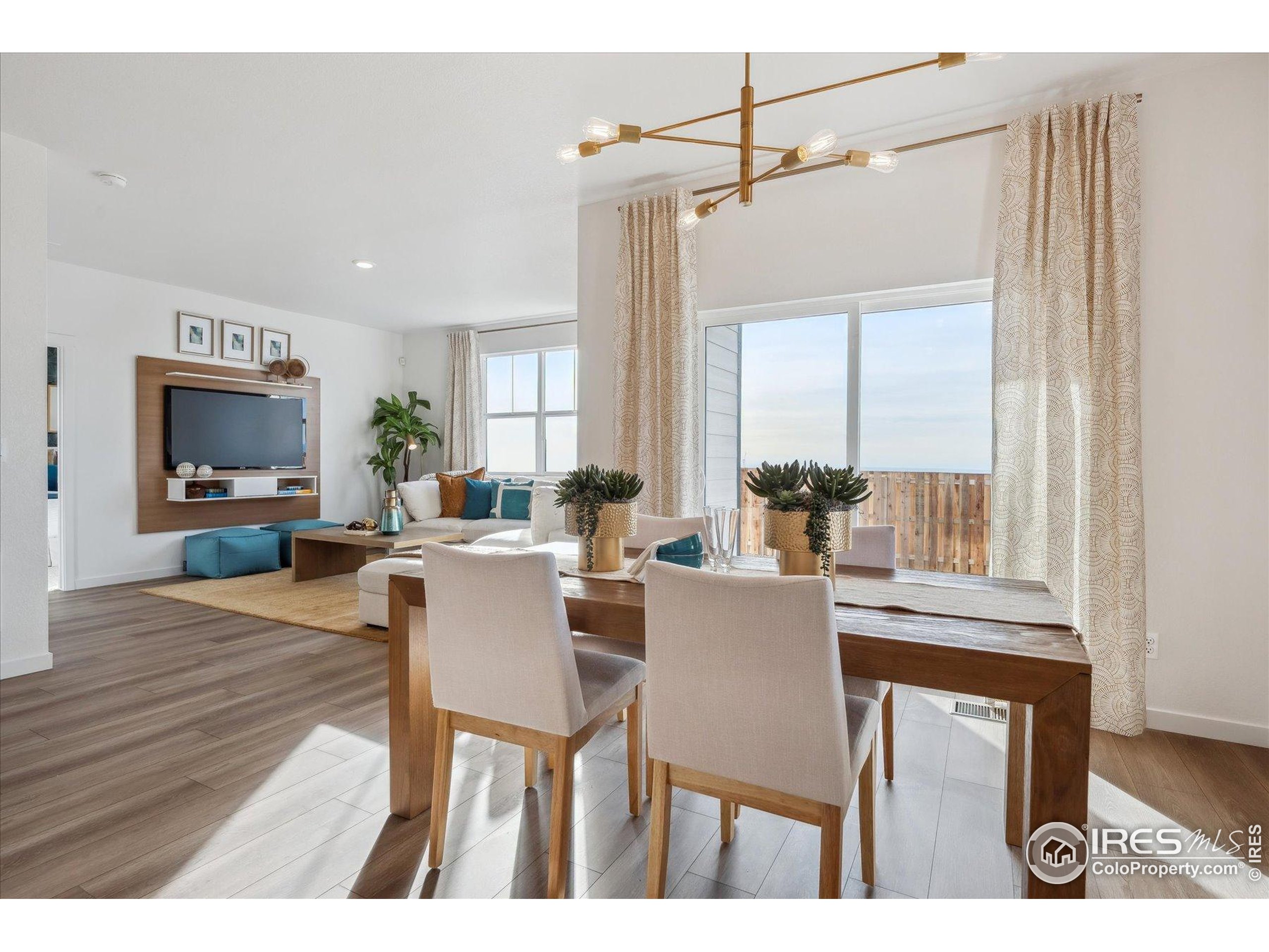 2207 Crosswind Street Fort Lupton, CO 80621 - Photo 11 of 26 a view of a dining room with furniture window and wooden floor