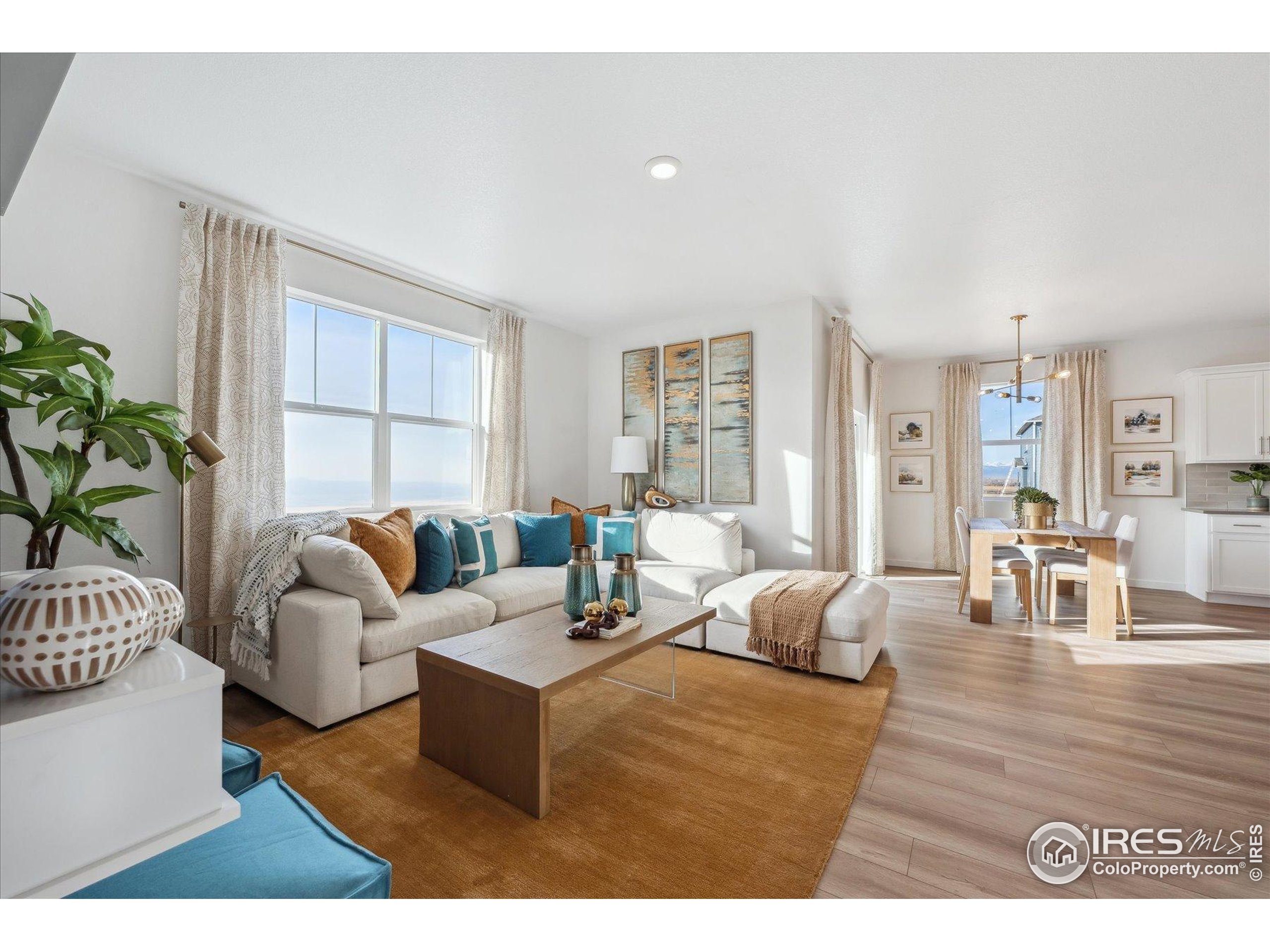 2207 Crosswind Street Fort Lupton, CO 80621 - Photo 15 of 26 a living room with furniture potted plant and a large window