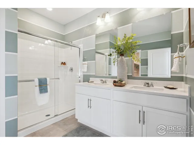 a bathroom with a sink double vanity and a mirror