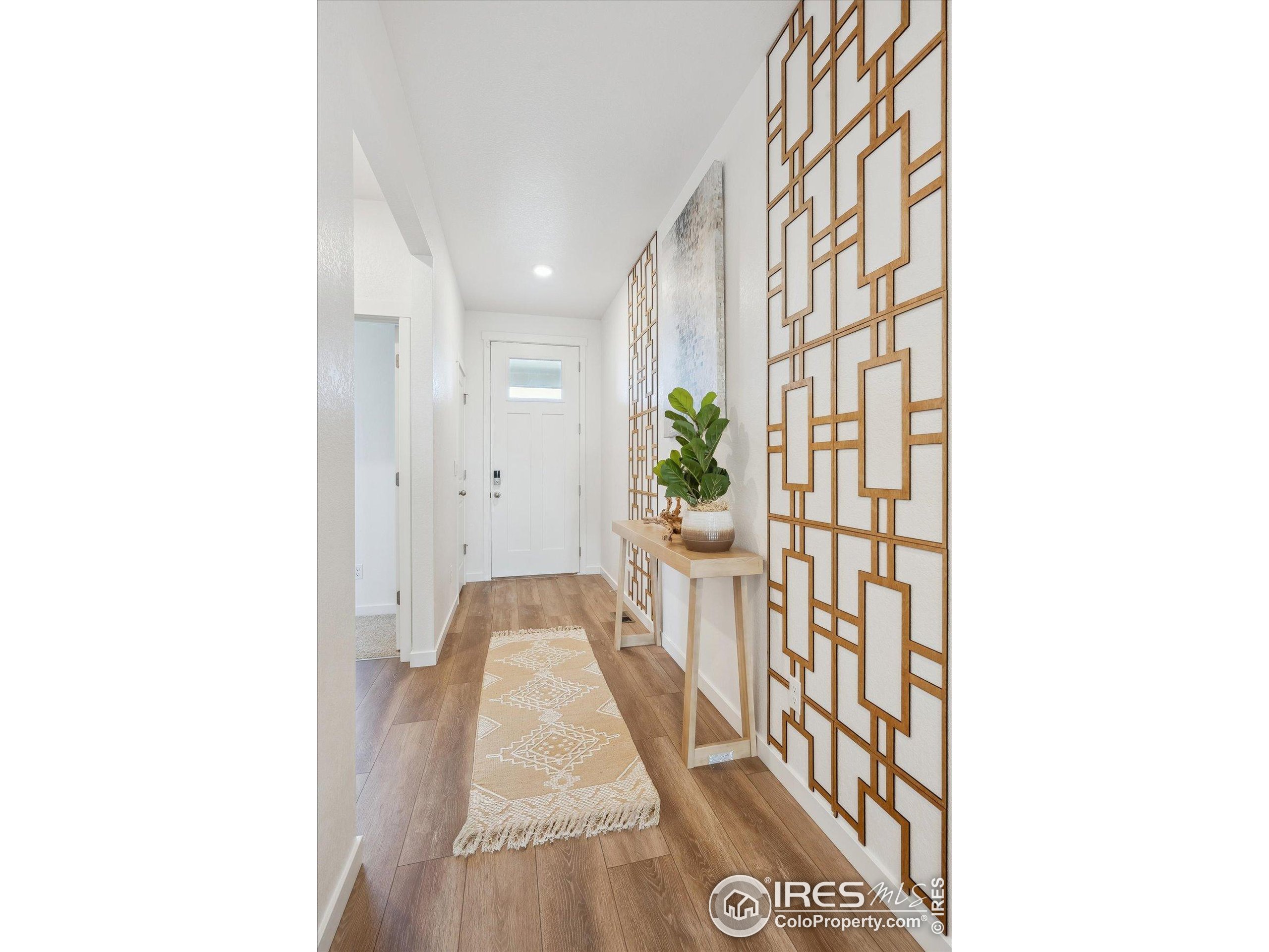 2207 Crosswind Street Fort Lupton, CO 80621 - Photo 2 of 26 a view of a hallway and a dining room