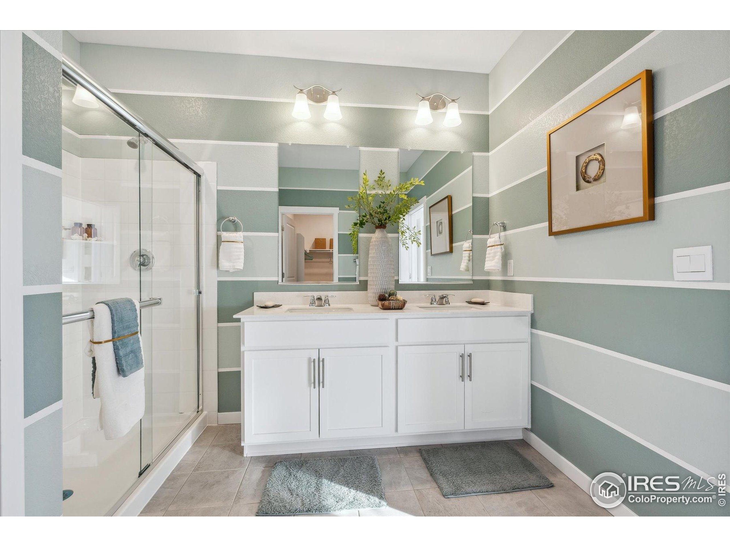 2207 Crosswind Street Fort Lupton, CO 80621 - Photo 21 of 26 a bathroom with a sink a mirror and a shower